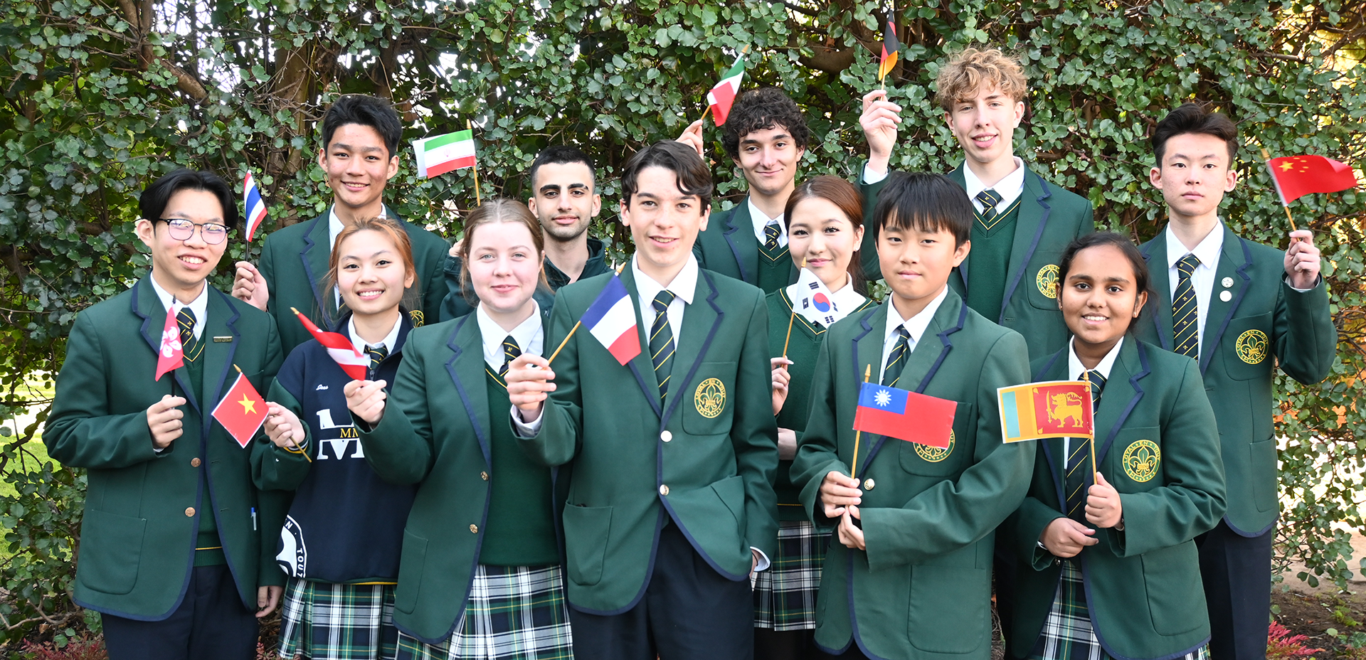 Mercedes College students celebrate cultural diversity, holding flags from around the world in their school uniforms.